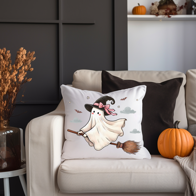 a white couch with a halloween pillow on it