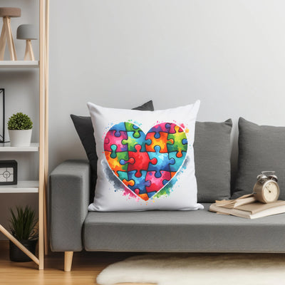 a heart shaped puzzle piece pillow on a couch