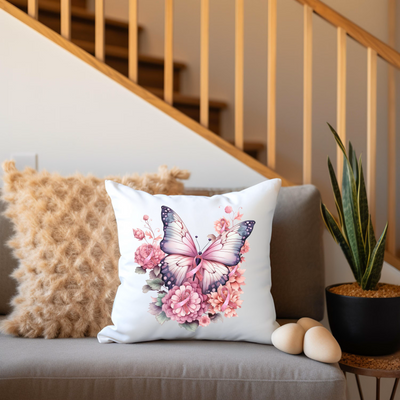 a white pillow with a pink butterfly on it