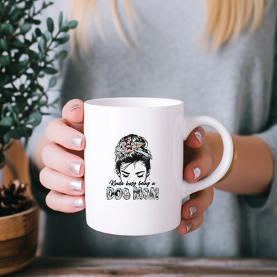 a woman holding a white coffee mug with a picture of a woman's face