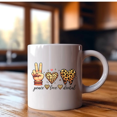 a white coffee mug with peace, love, and leopard print