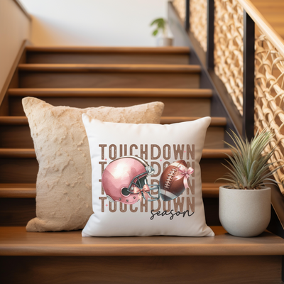 a pillow sitting on top of a wooden bench next to a plant