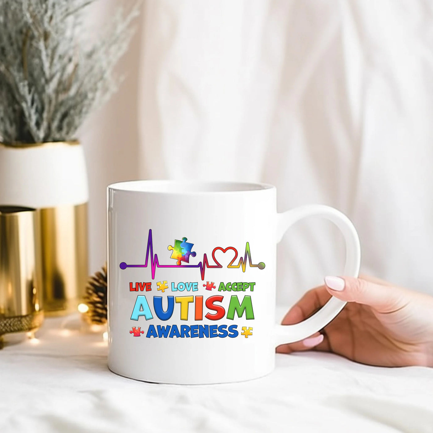 a person holding a coffee mug with the words autism on it