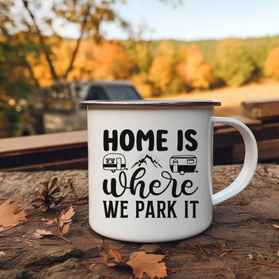 a camper mug sitting on the ground with the words home is where we park