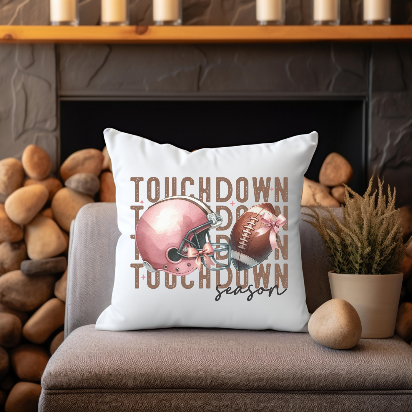 a football pillow sitting on top of a couch next to a potted plant