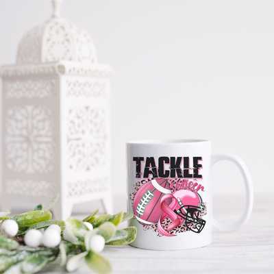 a coffee mug with a pink ribbon on it