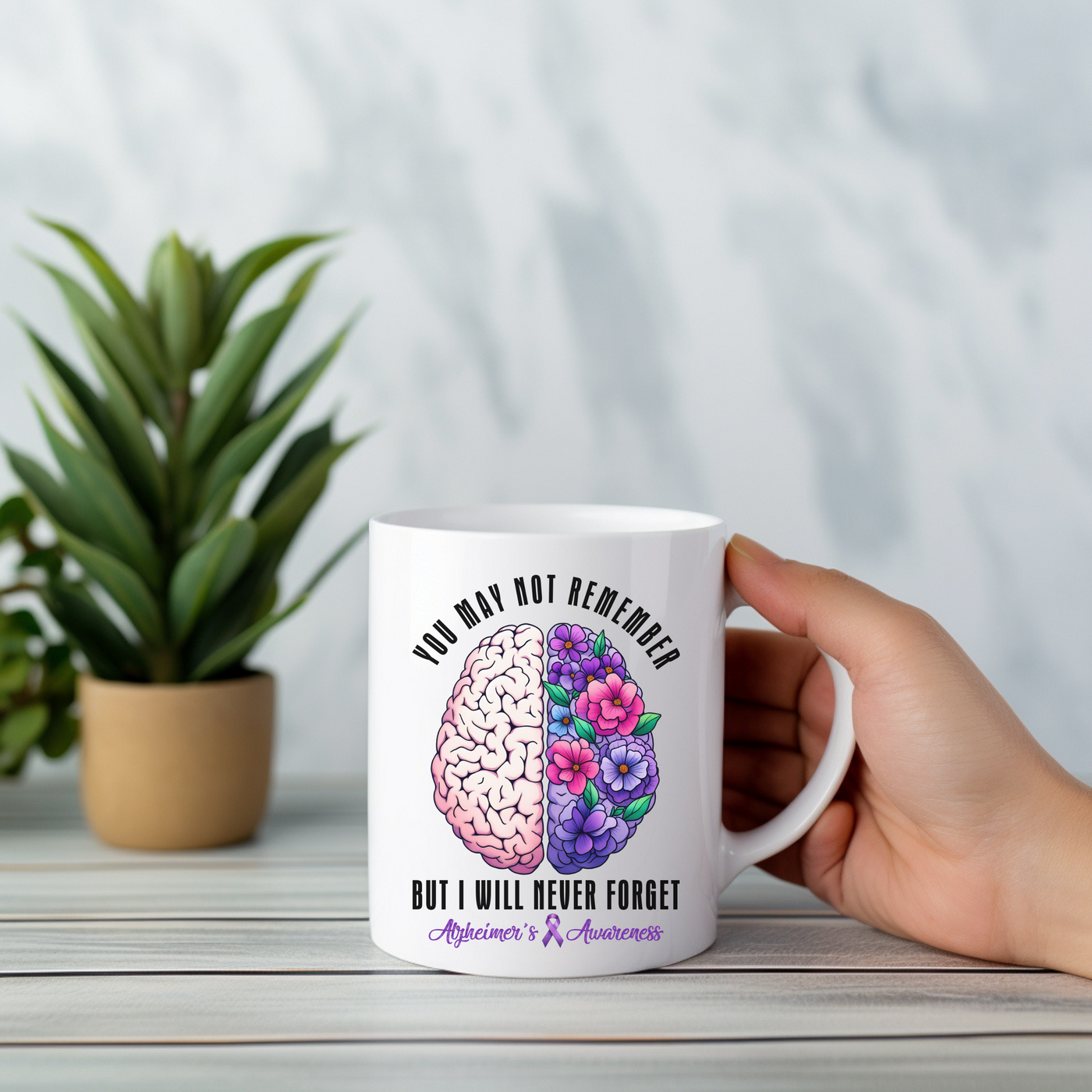 a person holding a coffee mug with a picture of a brain on it