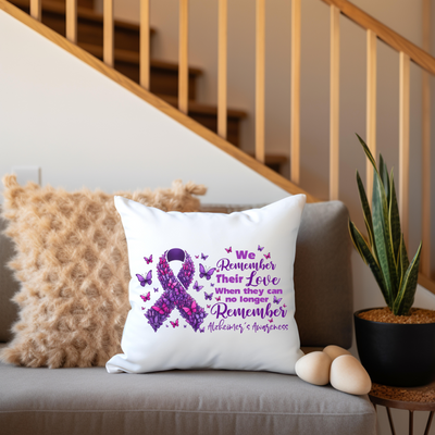 a pillow on a couch with a purple ribbon on it