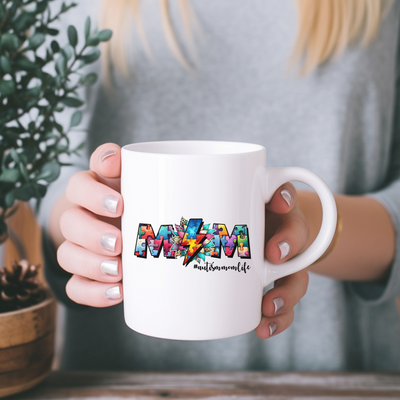 a woman holding a coffee mug with the word mom on it