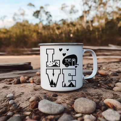 a white camper mug sitting on top of a pile of rocks