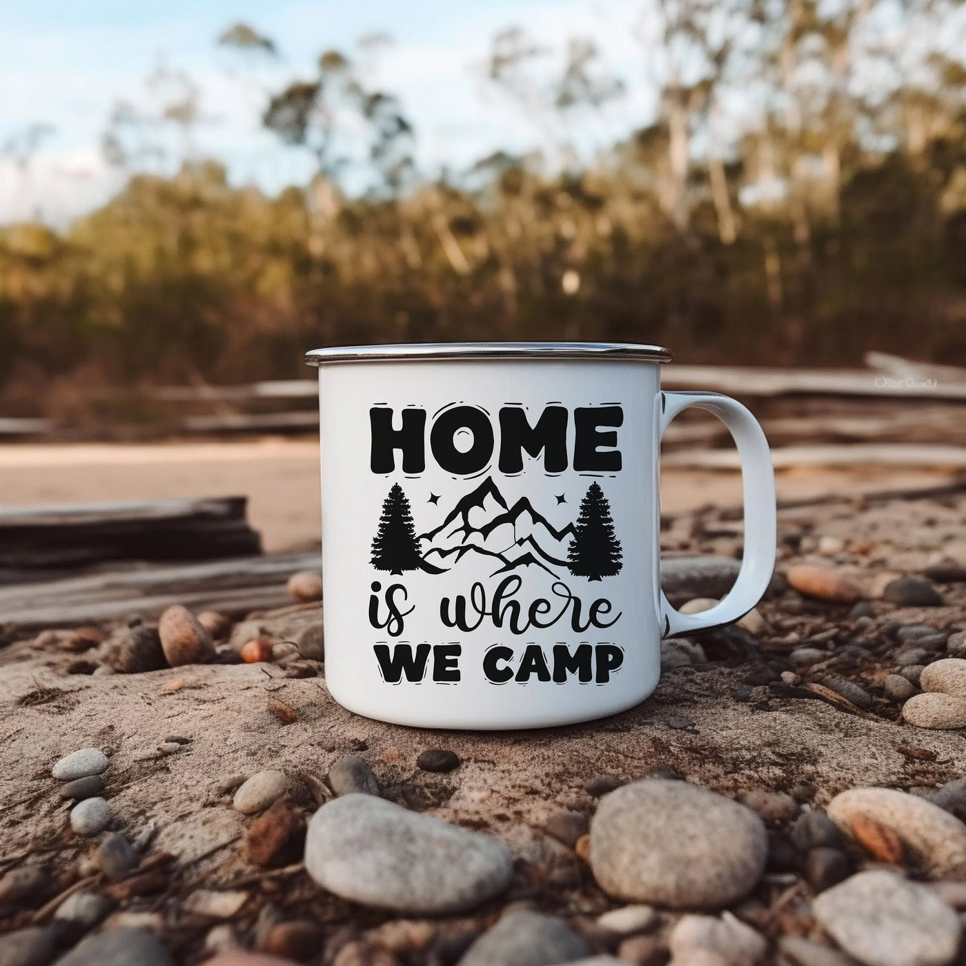 a white coffee mug sitting on top of a pile of rocks