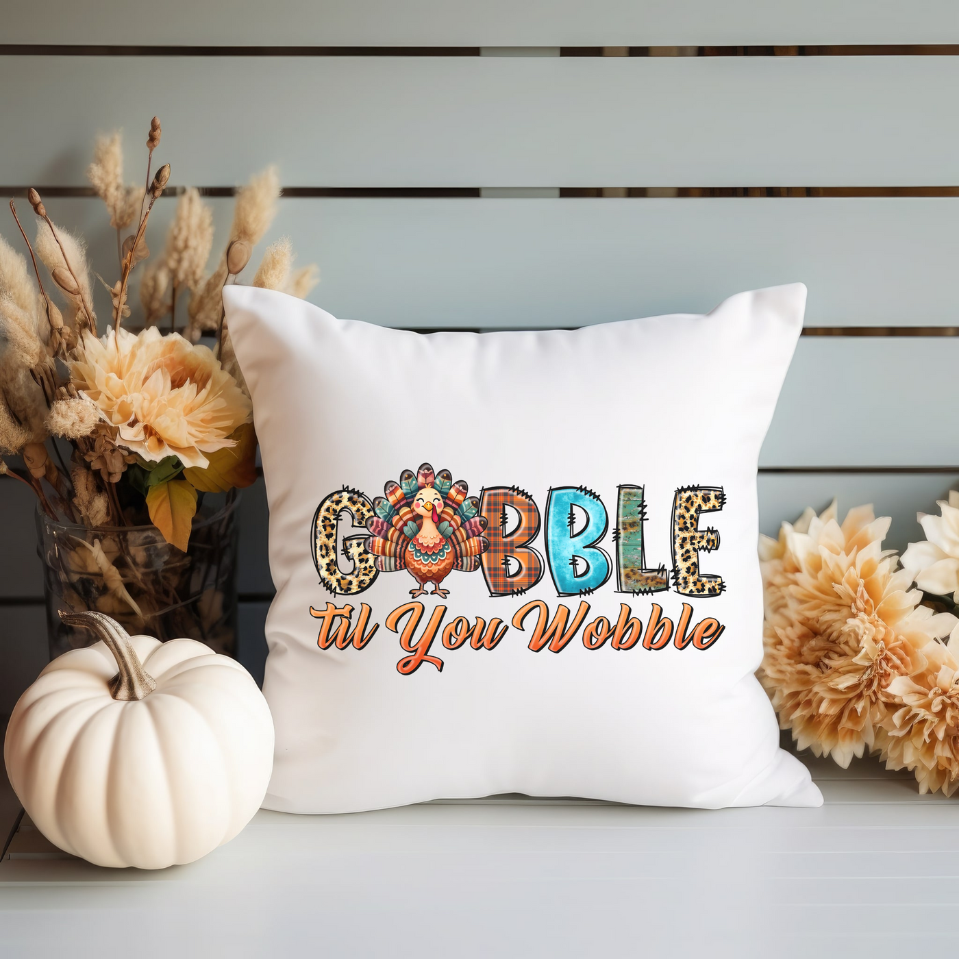 a white pillow with the words gobble in a decorative font