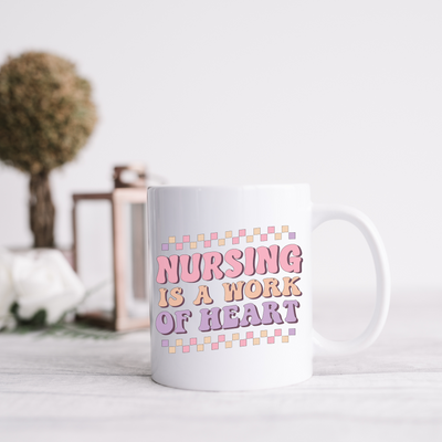 a white coffee mug with the words nursing is a work of heart