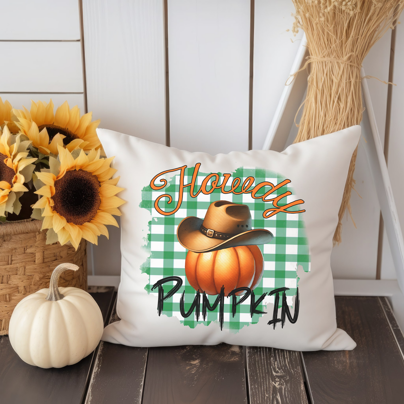 a pumpkin pillow sitting on top of a wooden table