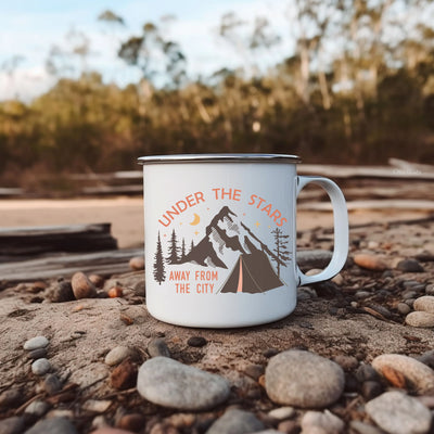 a camp mug sitting on a rocky ground