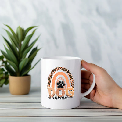 a person holding a coffee mug with a dog on it