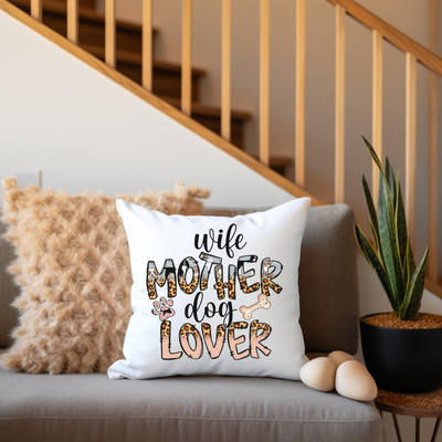 a white pillow sitting on top of a couch next to a plant