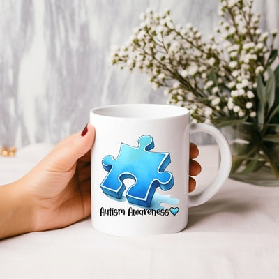 a person holding a coffee mug with a puzzle piece on it