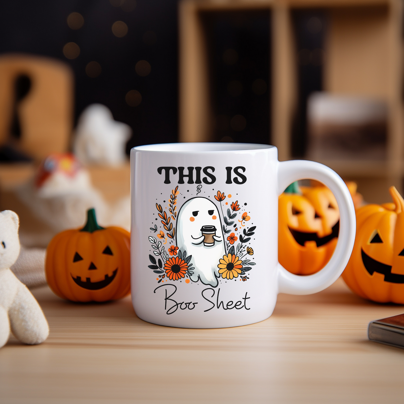 a white coffee mug with a ghost and pumpkins around it