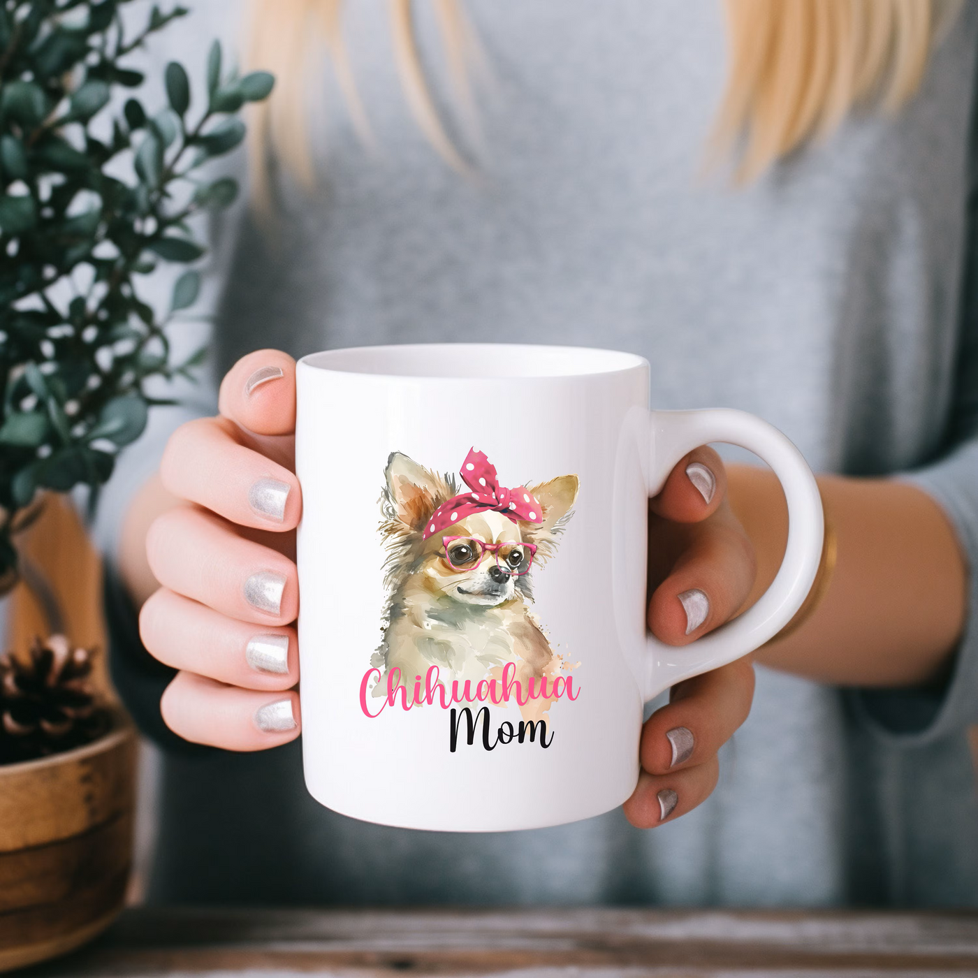 a woman holding a coffee mug with a dog on it