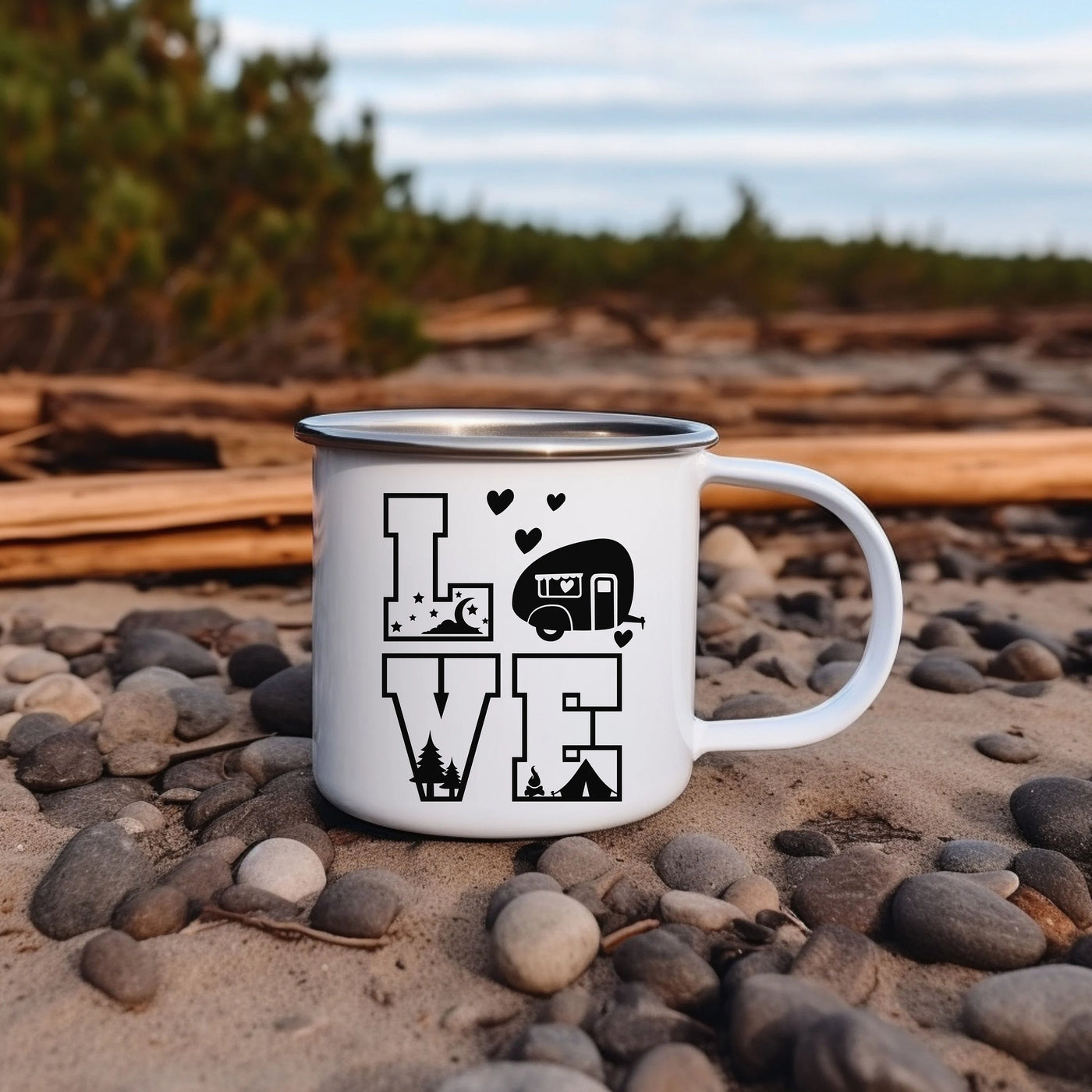 a white camper mug sitting on top of a pile of rocks