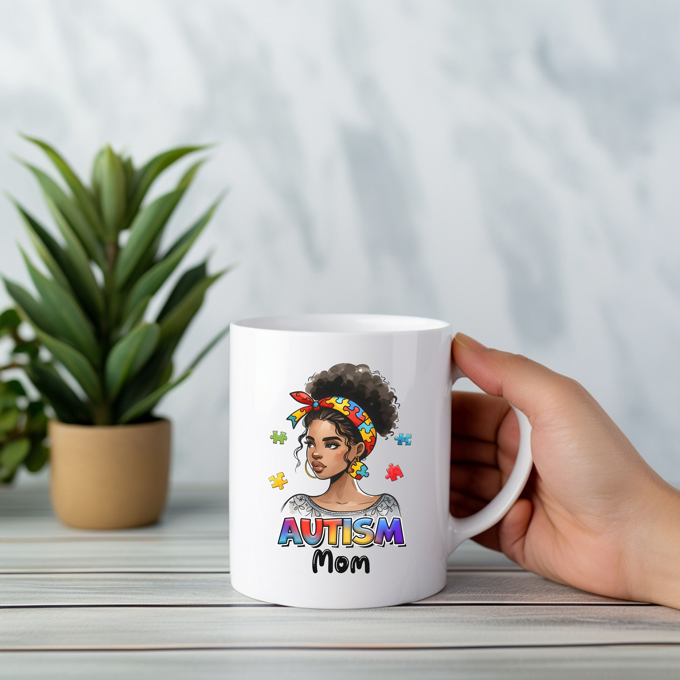 a person holding a coffee mug with an image of a woman on it