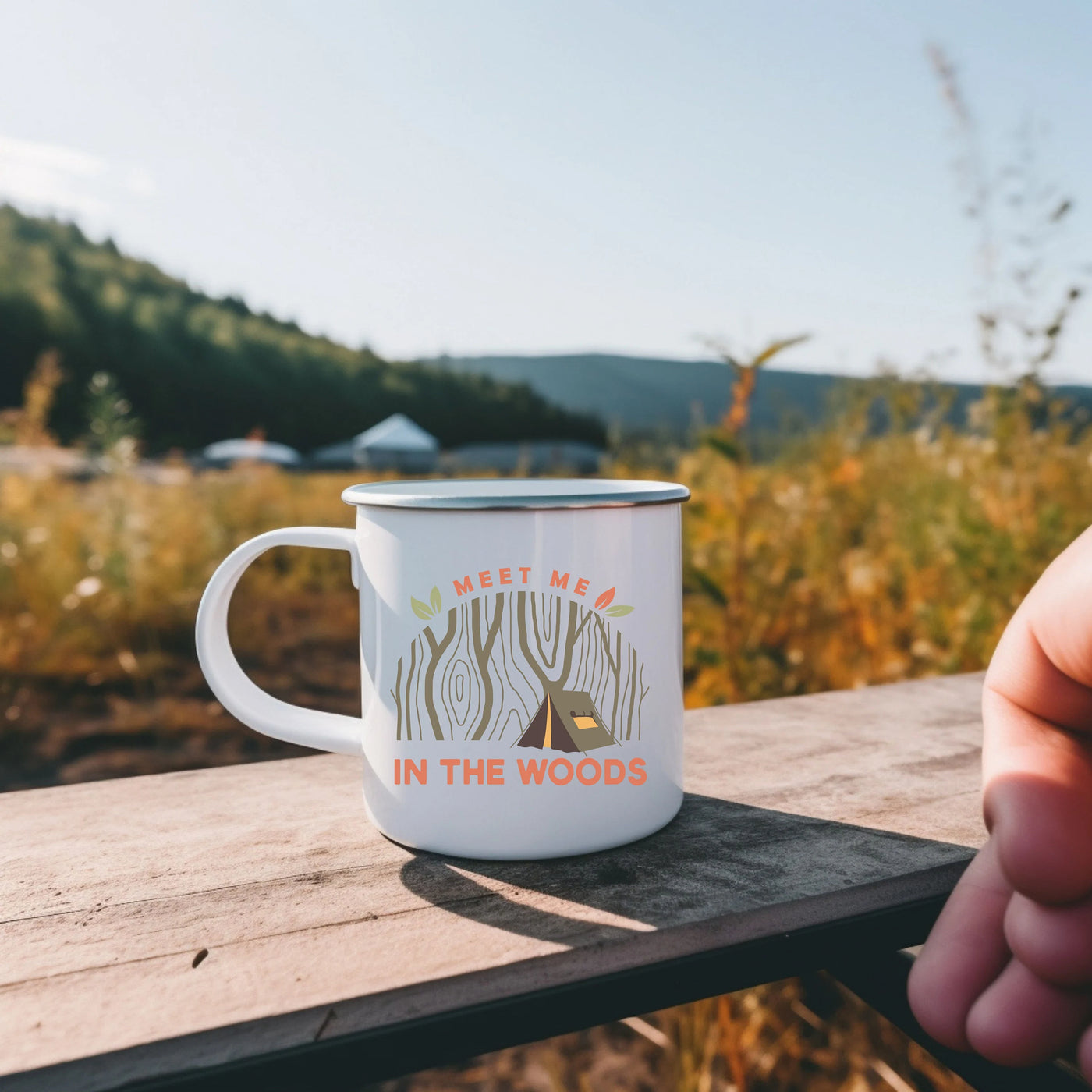 a person holding a coffee mug on a wooden table