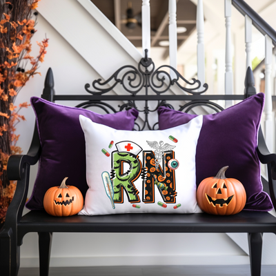 a bench with two pumpkins and a pillow on it