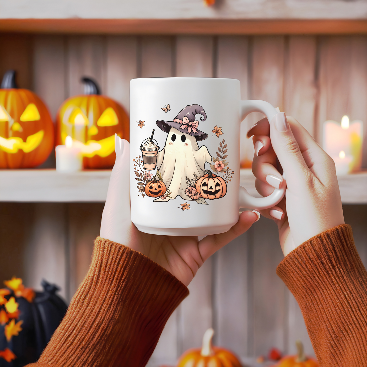 a person holding a coffee mug with a ghost on it