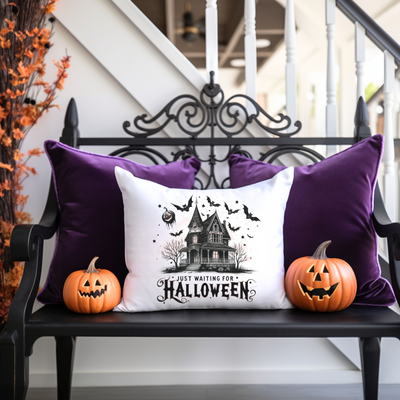 a bench with two pumpkins and a pillow on it