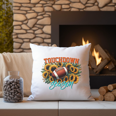 a throw pillow sitting on a couch next to a fire place