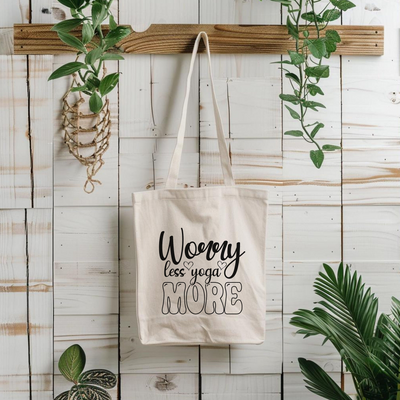 a tote bag hanging on a wall next to a potted plant