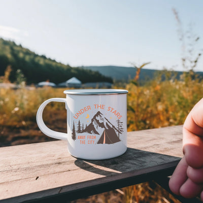 a person holding a coffee mug on a wooden table