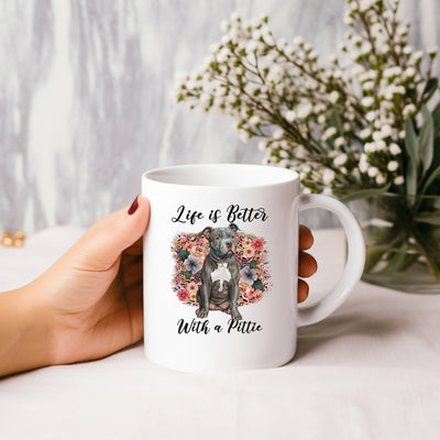 a person holding a coffee mug with a dog on it