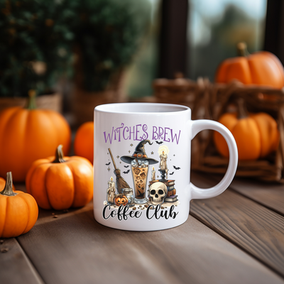 a white coffee mug with witches brew on it