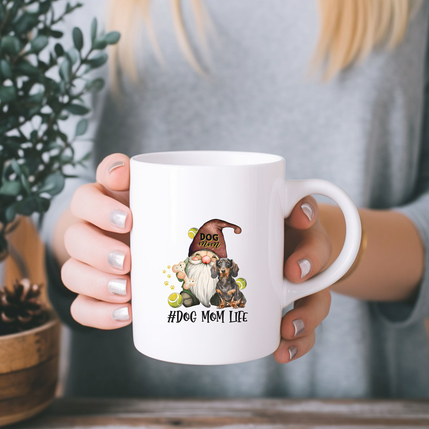 a woman holding a coffee mug with a gnome on it