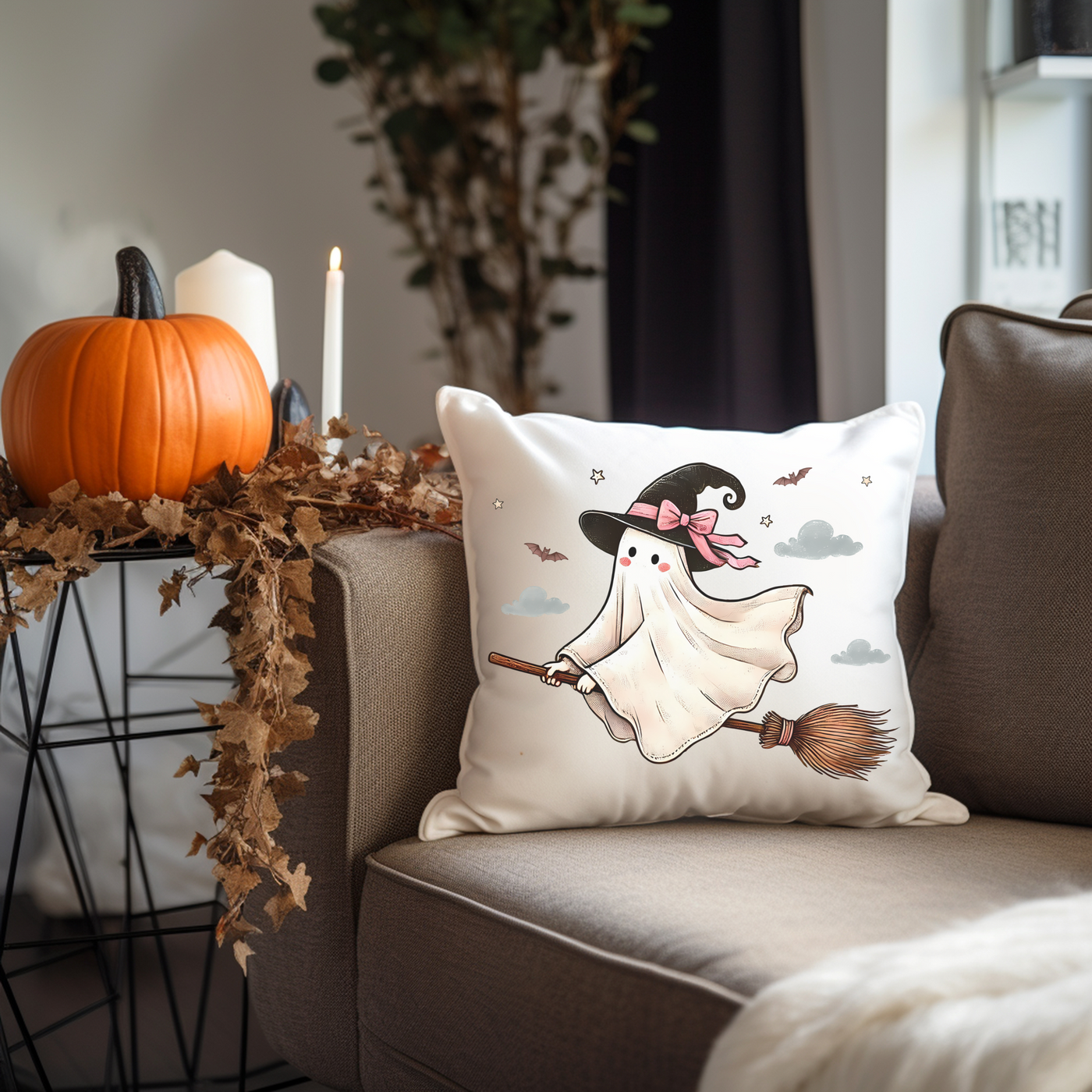 a pillow with a witch on it sitting on a couch