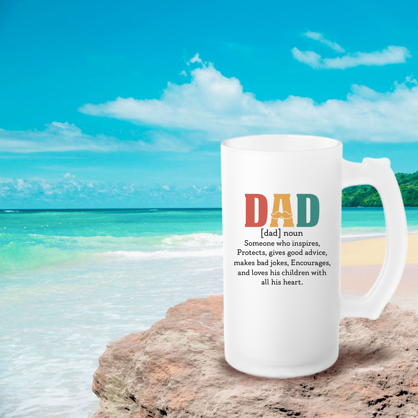 a white coffee mug sitting on top of a beach