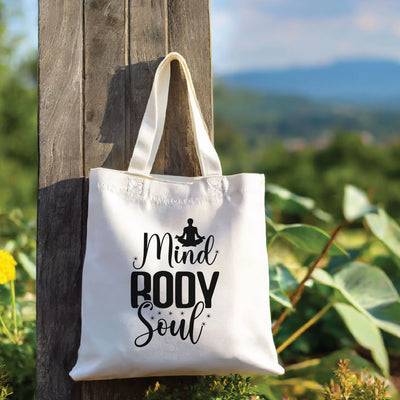 a white tote bag hanging on a wooden pole