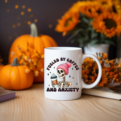 a coffee mug with a skull holding a cup of coffee