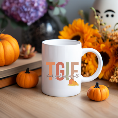 a white coffee mug sitting on top of a wooden table