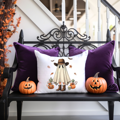 a bench with two pumpkins and a pillow on it