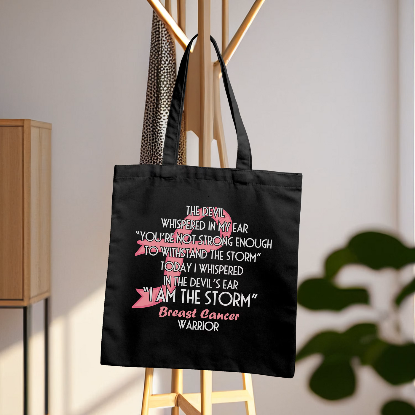 a black shopping bag hanging on a clothes rack