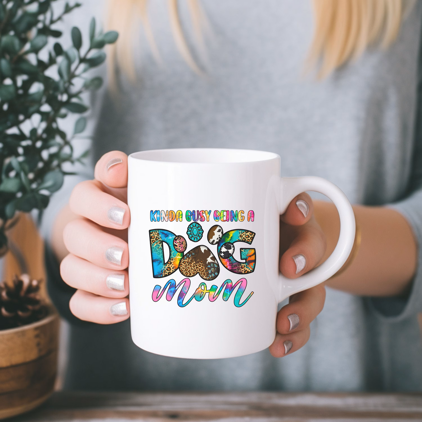 a woman holding a coffee mug with a dog on it