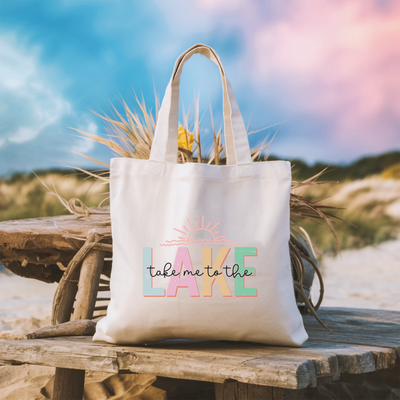 a white tote bag sitting on top of a wooden bench