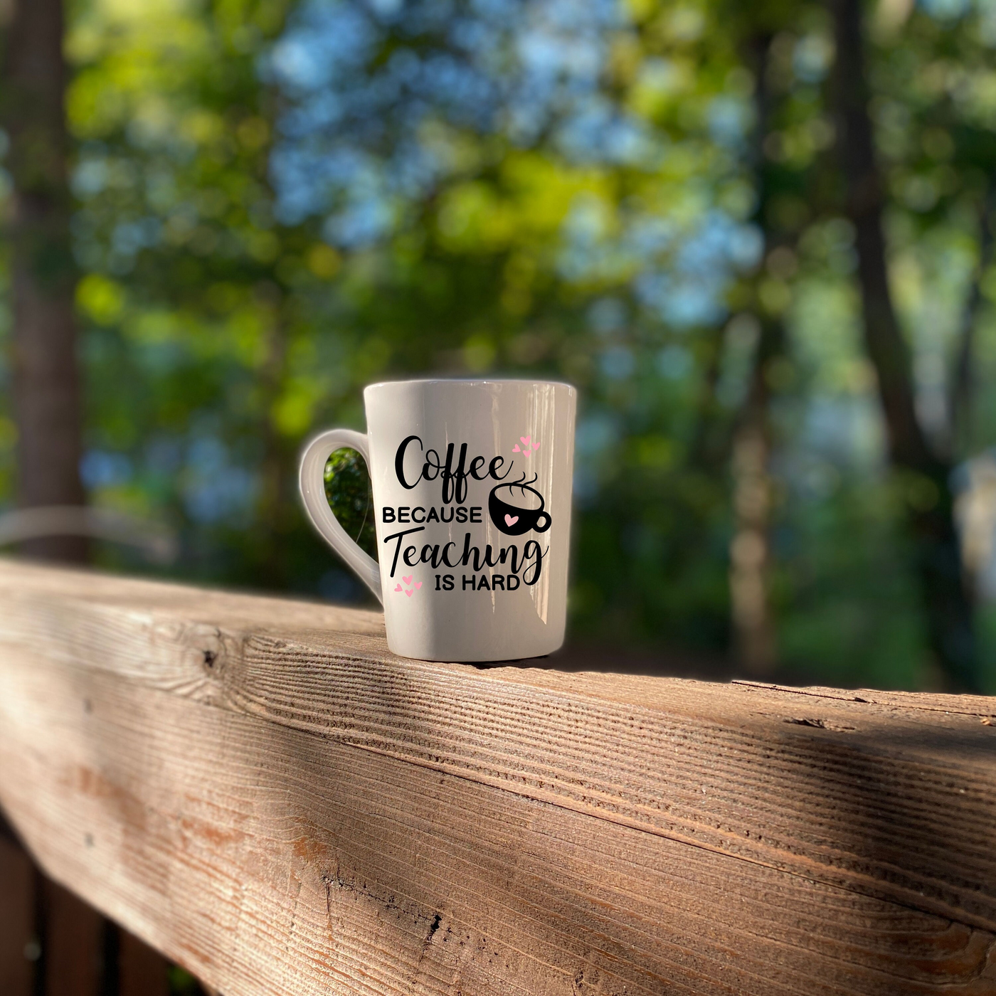 a coffee mug sitting on top of a wooden fence