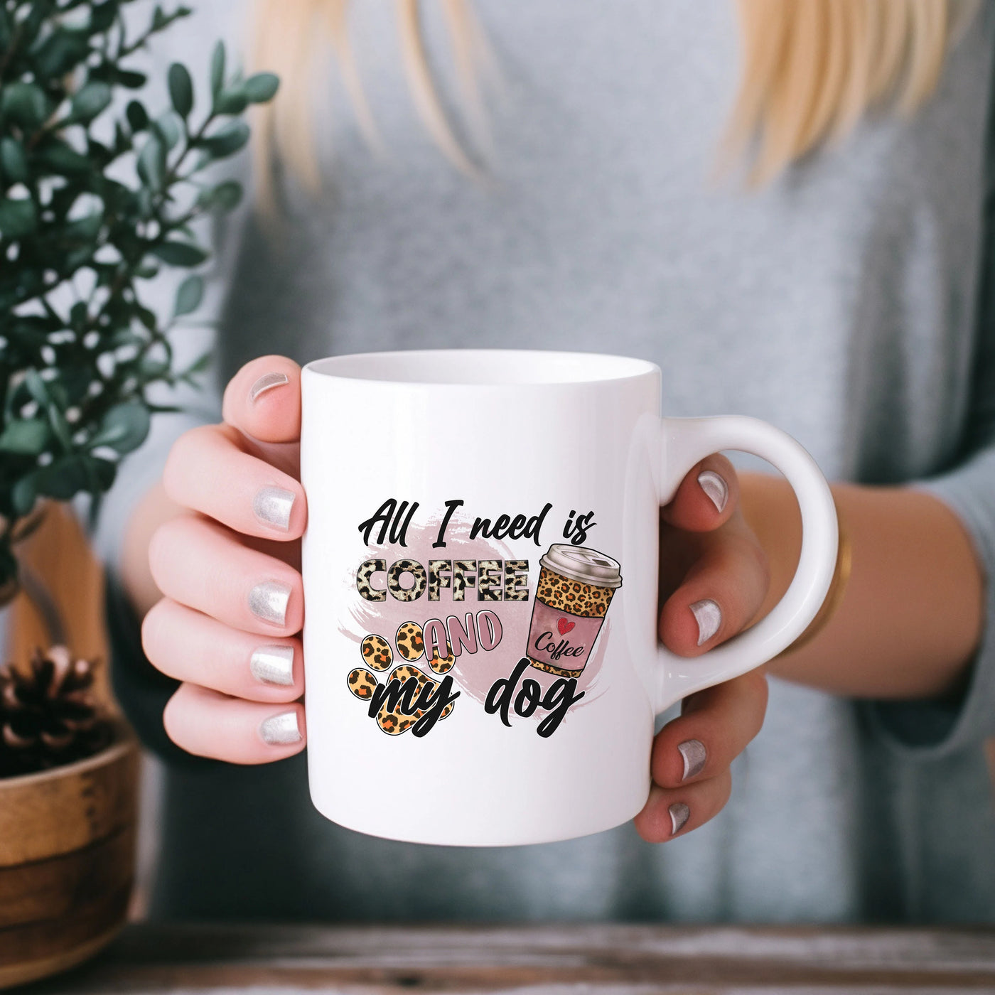 a woman holding a coffee mug in her hands