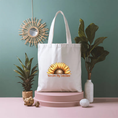 a white tote bag sitting on top of a pink table