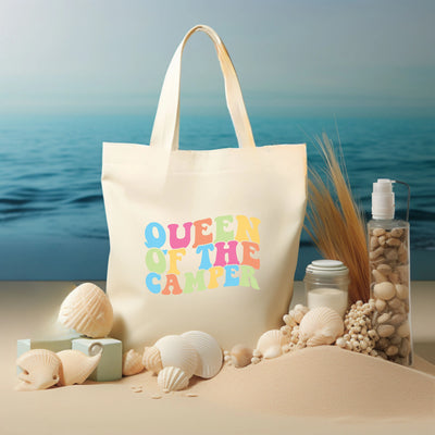 a tote bag sitting on top of a sandy beach