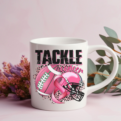 a pink coffee mug with a football helmet and helmet on it